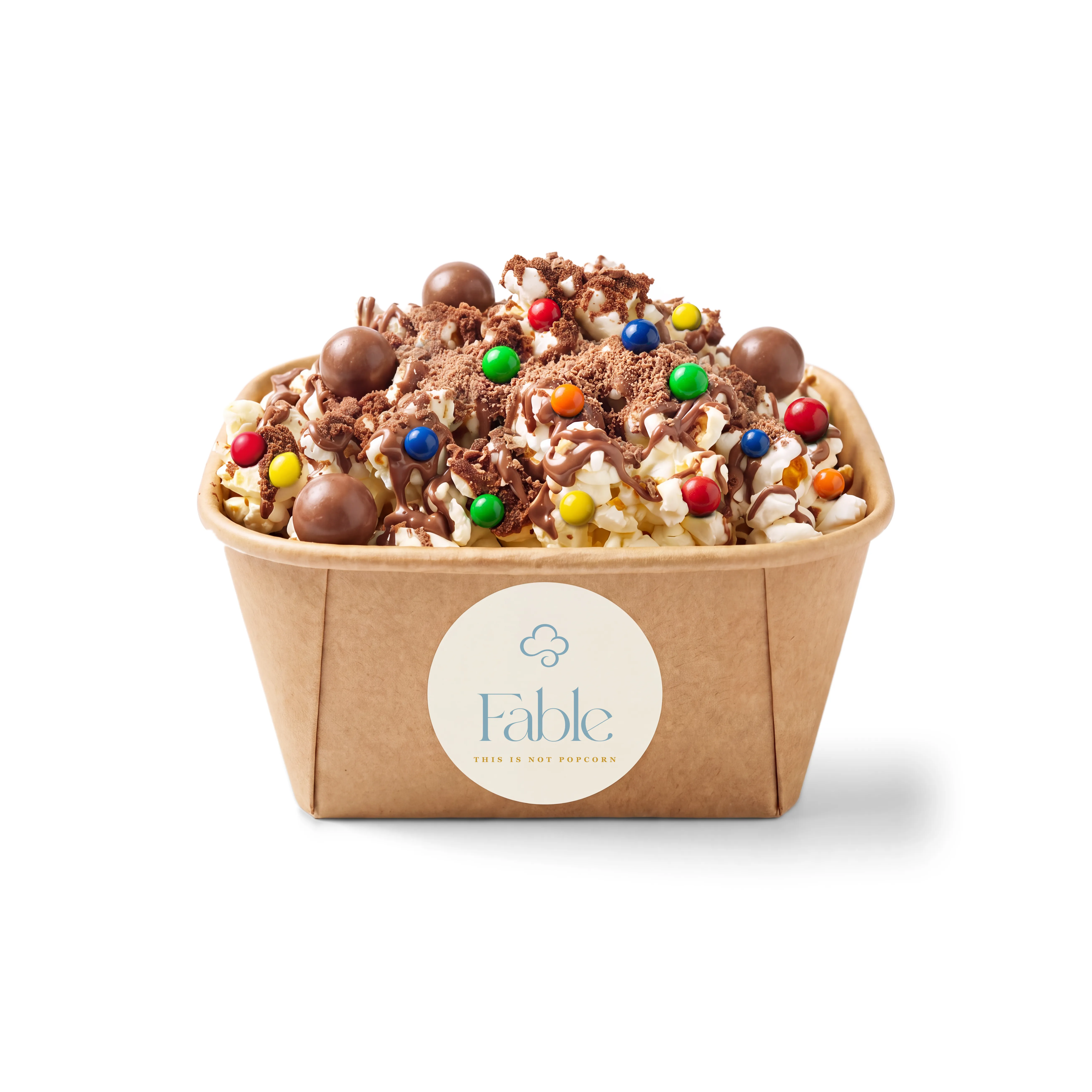 A kraft Fable tub of Chocolate Spell popcorn with a chocolatey drizzle and crumble, dotted with round treats in bright colours.